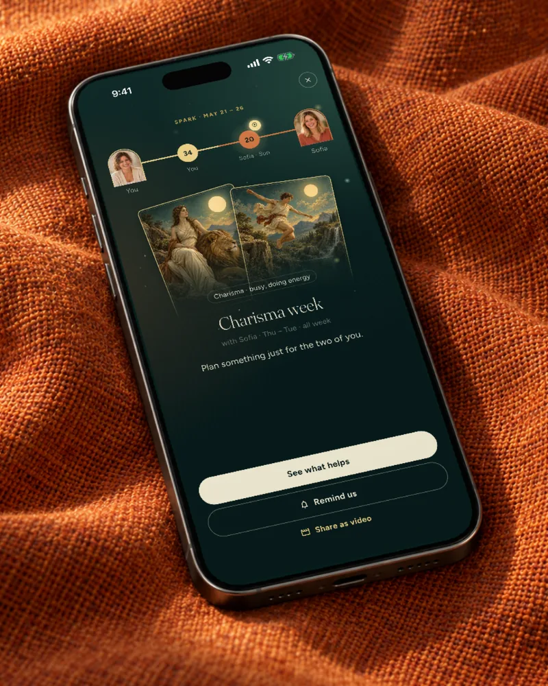 An iPhone on rust-red cloth shows the moment Charisma week