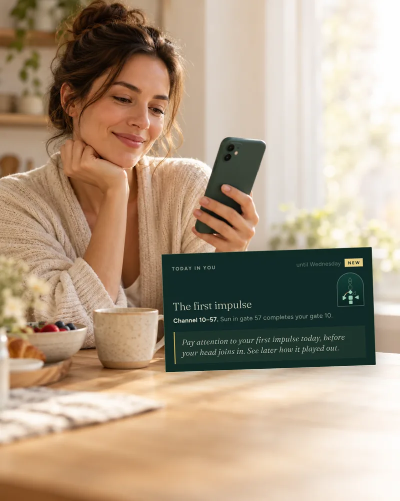 A woman at the breakfast table looks at her phone, next to her the card Today in you: The first impulse